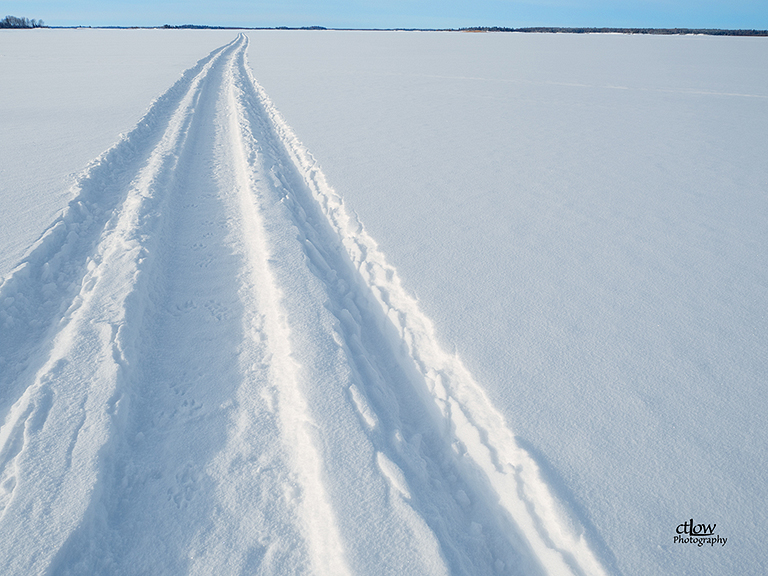 Snowmobile track on solidly frozen lake