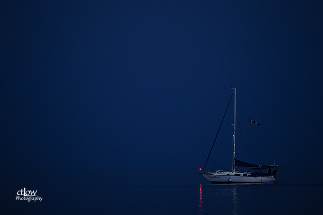 sailboat return harbour dusk